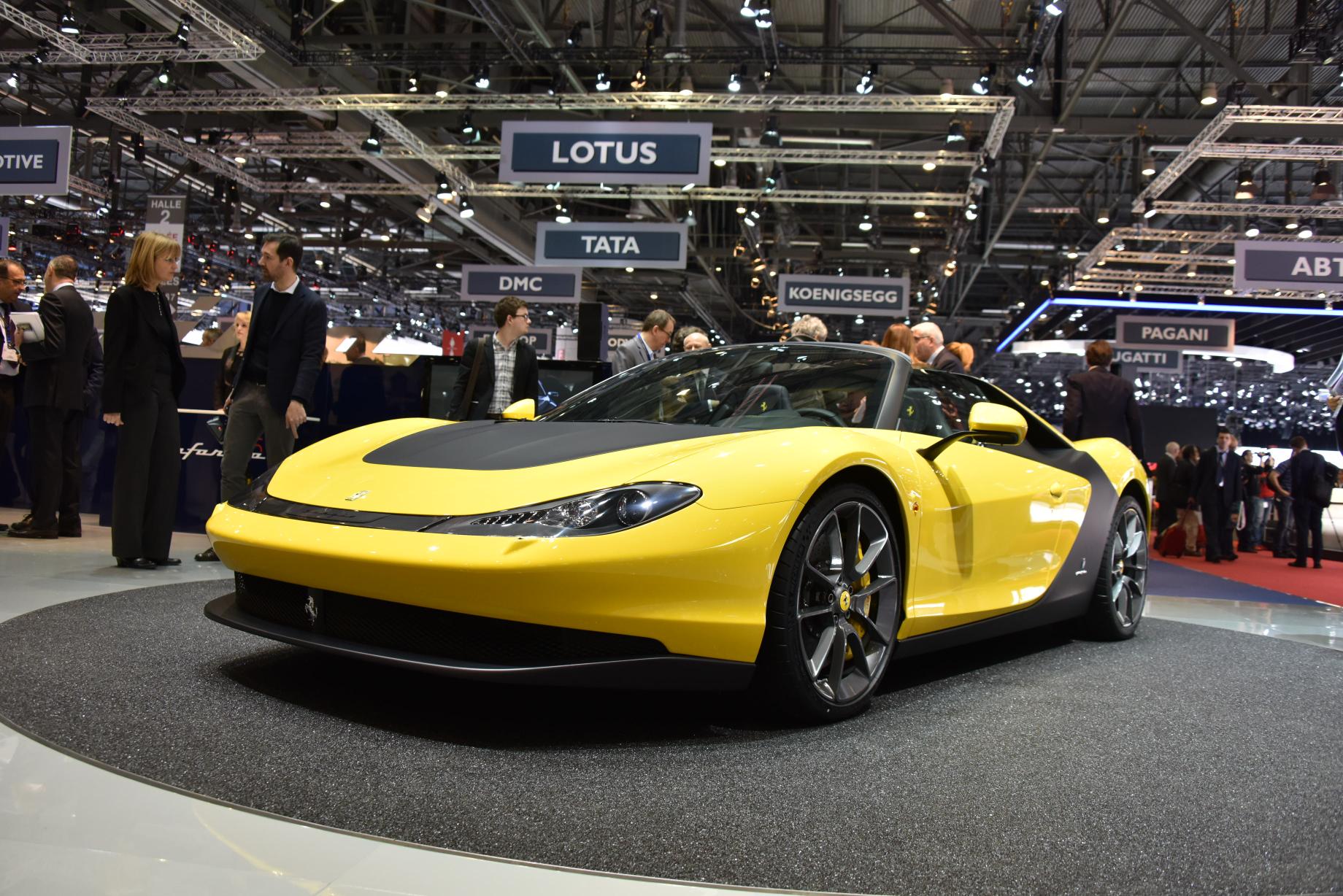 A yellow/black Ferrari Pininfarina Sergio, facing left, displayed at a motor show.
